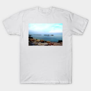 Calm Adriatic sea surrounded by massive rocks under the light blue sky T-Shirt